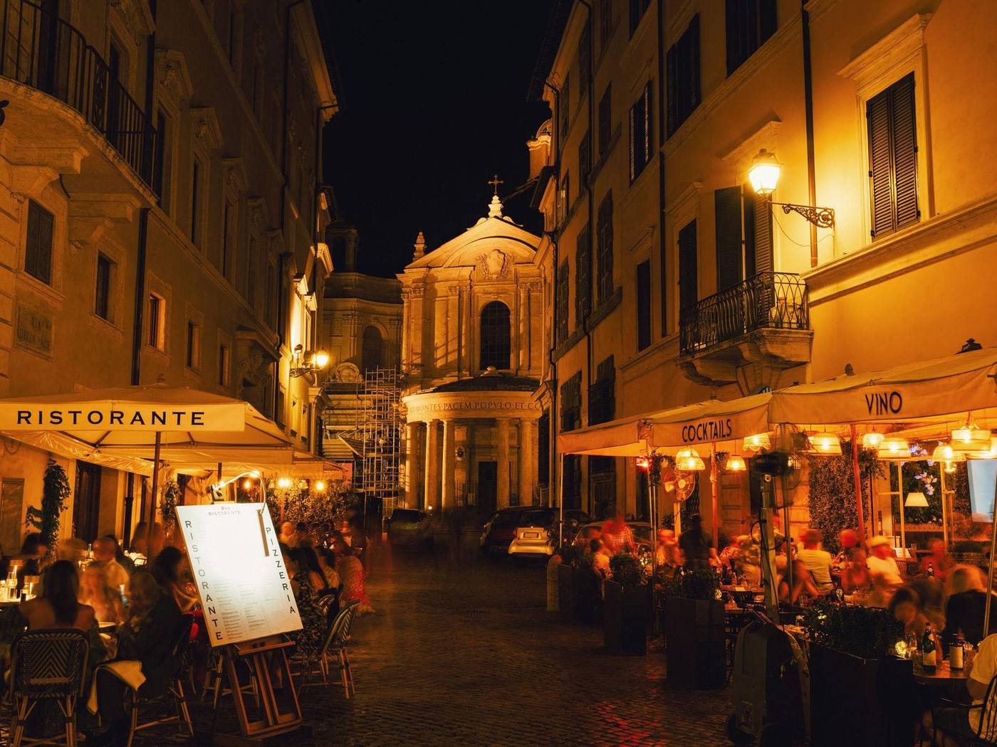 Cozy Roman trattoria street at night